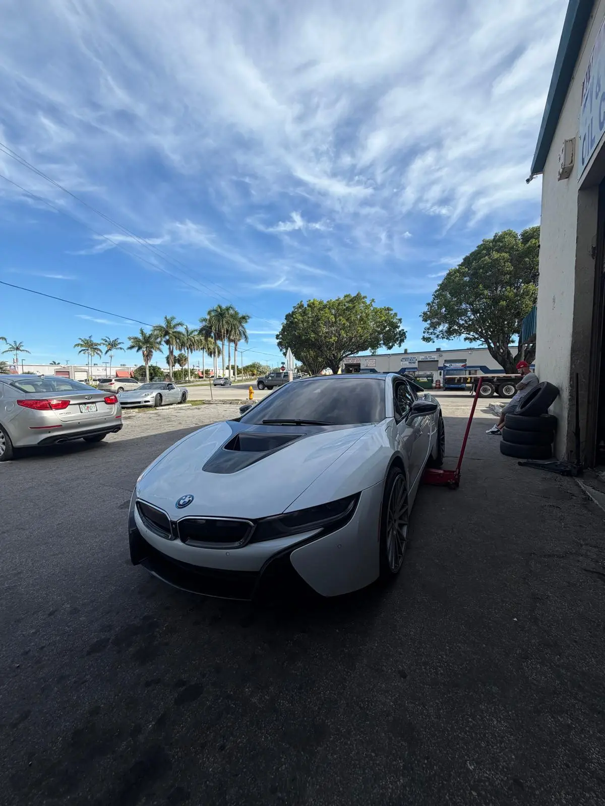 BMW i8 jacked up outside the shop